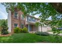 Beautiful two-story home with a mix of brick and vinyl siding, blue shutters and a lovely lawn at 6562 Quail Run, Fishers, IN 46038