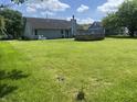 Expansive backyard with lush green grass and mature trees, perfect for outdoor gatherings and activities at 6932 Deerbrook Ct, Indianapolis, IN 46214