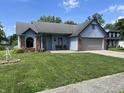 Inviting one-story home with lush lawn, brick accents, and attached garage in a desirable neighborhood at 6932 Deerbrook Ct, Indianapolis, IN 46214