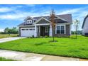 Beautiful home with well-kept lawn, lovely landscaping, and a cozy front porch at 7205 Rose Hill Ave, Brownsburg, IN 46112