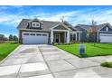 Attractive home featuring a spacious driveway, attached garage, and a well-maintained lawn at 7205 Rose Hill Ave, Brownsburg, IN 46112