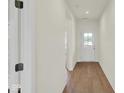 Bright hallway with hardwood flooring leading to a glass door at 7205 Rose Hill Ave, Brownsburg, IN 46112