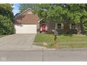 Charming brick home with a well-maintained lawn, mature tree, and red front door at 7239 N Orchard Dr, Indianapolis, IN 46236