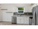 Modern kitchen featuring stainless appliances, granite counters and white cabinetry at 7239 N Orchard Dr, Indianapolis, IN 46236