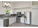 Modern kitchen featuring stainless appliances, granite counters and white cabinetry at 7239 N Orchard Dr, Indianapolis, IN 46236