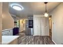 Stylish kitchen with a stainless steel refrigerator, and an elegant pendant light, creating a culinary haven at 7719 Grandview Dr, Indianapolis, IN 46260