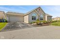 Well-maintained home with a beige exterior, a two-car garage, and a paved driveway at 7850 King Post Dr, Indianapolis, IN 46237