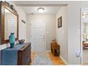 A welcoming foyer with hardwood floors, a decorative mirror, and neutral wall colors at 7850 King Post Dr, Indianapolis, IN 46237