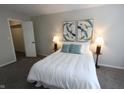 Inviting bedroom with a comfortable queen-sized bed, soft carpet, and modern decor at 9323 Doubloon Rd, Indianapolis, IN 46268