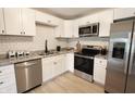 Beautiful kitchen with white cabinets, stainless steel appliances, and granite countertops at 9323 Doubloon Rd, Indianapolis, IN 46268