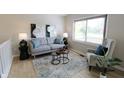 Cozy living room with a comfortable couch, area rug, and bright window at 9323 Doubloon Rd, Indianapolis, IN 46268