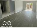 Spacious living room featuring modern wood floors and a sliding glass door for natural light at 9458 Fordham St, Indianapolis, IN 46268
