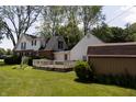 Exterior showcasing a wooden deck, fenced yard, and the back of a two-story house with white siding and brick accents at 980 W Poplar St, Zionsville, IN 46077