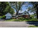 Charming home with brick and siding exterior, complemented by a spacious yard and an attached garage at 980 W Poplar St, Zionsville, IN 46077