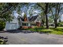 Lovely home with brick and siding exterior, paved driveway, attached garage, and well-maintained lawn at 980 W Poplar St, Zionsville, IN 46077