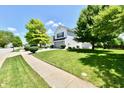 A charming two-story home with a well-manicured lawn and mature trees at 10539 Ross Xing, Fishers, IN 46038