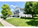 A charming two-story home with a well-manicured lawn and mature trees at 10539 Ross Xing, Fishers, IN 46038