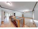 Open-concept living space featuring hardwood floors, carpeted areas, and a view of the kitchen and fireplace at 11 N Restin Rd, Greenwood, IN 46142