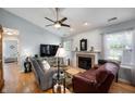 Comfortable living room with fireplace, ceiling fan, and ample natural light at 1112 Berwyn Rd, Whiteland, IN 46184