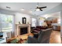 Open living area with fireplace, ceiling fan, and seamless flow to the kitchen at 1112 Berwyn Rd, Whiteland, IN 46184