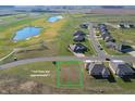 Aerial view of a large vacant lot near houses, green golf courses, and a pond at 1130 Constitution Dr, Edinburgh, IN 46124