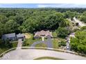 Expansive aerial view of home showcasing lush surroundings, circular driveway, and neighborhood at 12674 Banbury Cir, Carmel, IN 46033