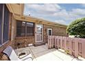 Rear patio featuring a partially fenced yard, brick exterior, and sunny view at 13 Marywood Dr, Greenfield, IN 46140
