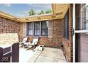 Outdoor patio area with seating, showcasing brick exterior and natural light at 13 Marywood Dr, Greenfield, IN 46140