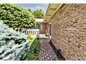 Close up of brick pathway leading to the house, surrounded by lush greenery and landscaping at 13 Marywood Dr, Greenfield, IN 46140