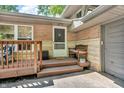 Charming front porch with seating, a small bench, brick accents, and a cozy entrance at 1340 Eustis Dr, Indianapolis, IN 46229