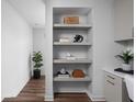 Hallway niche with stylish decorative objects on floating shelves, next to office and plant at 1461 Whistle Way, Westfield, IN 46074