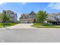Charming two-story home with three-car garage and landscaped yard on a sunny day at 15813 Arthur Jacob Ln, Noblesville, IN 46060