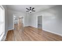 Bright living room with hardwood floors and a ceiling fan, open layout to other rooms at 1641 Deloss St, Indianapolis, IN 46201