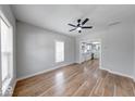 Bright living room with hardwood floors and a ceiling fan, open to modern kitchen at 1641 Deloss St, Indianapolis, IN 46201