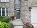 Inviting front entrance with decorative plants and a well-lit porch, number 1680 at 1680 Woodfield Dr, Greenwood, IN 46143
