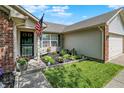 Inviting front yard with well-kept landscaping, flowers, and an American flag at 17401 Austrian Pine Way, Westfield, IN 46074