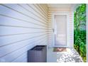 Inviting covered porch with a screen door, neutral siding, exterior light, and an outdoor wicker container at 1856 Misty Lake Dr, Indianapolis, IN 46260