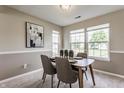 Inviting dining area with stylish table, chairs, and bright windows overlooking the yard at 19469 Amber Way, Noblesville, IN 46060