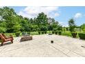 Spacious backyard with a stamped concrete patio, basketball hoop, and mature trees at 2029 Seven Peaks Dr, Cicero, IN 46034