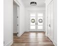 Bright foyer with wood floors and front door with decorative wreaths, and hallway at 20450 Chatham Hills Blvd, Westfield, IN 46074