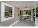 Inviting front porch featuring decorative railing and a view of the surrounding greenery at 3709 Central Ave, Indianapolis, IN 46205