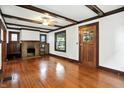 Cozy living room showcasing a brick fireplace, hardwood floors, and classic design at 39 N Bosart N Ave, Indianapolis, IN 46201