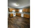 Traditional kitchen featuring wood cabinets, laminate countertops, and modern white appliances at 3929 Roundwood Dr, Indianapolis, IN 46235