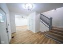 Bright entryway with hardwood floors, a staircase, and an open floor plan at 402 N Oxford St, Indianapolis, IN 46201