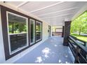 Open-air porch with brick pillars, fresh paint, and lots of natural light at 402 N Oxford St, Indianapolis, IN 46201
