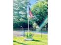 An American flag waving in the yard, complemented by vibrant greenery at 409 N Kyle St, Edinburgh, IN 46124