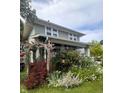 Quaint two-story home featuring beautiful flower garden, and wooden pergola at 430 W Locust St, Shelbyville, IN 46176
