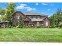 Charming brick home featuring a well-maintained lawn and mature landscaping at 4704 Pearcrest Way, Greenwood, IN 46143