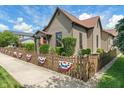 Charming home featuring a decorative fence, landscaped yard and classic architectural design at 718 E Washington St, Lebanon, IN 46052
