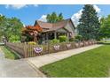Beautiful home with a decorative fence, lush landscaping, and a charming windmill accent at 718 E Washington St, Lebanon, IN 46052